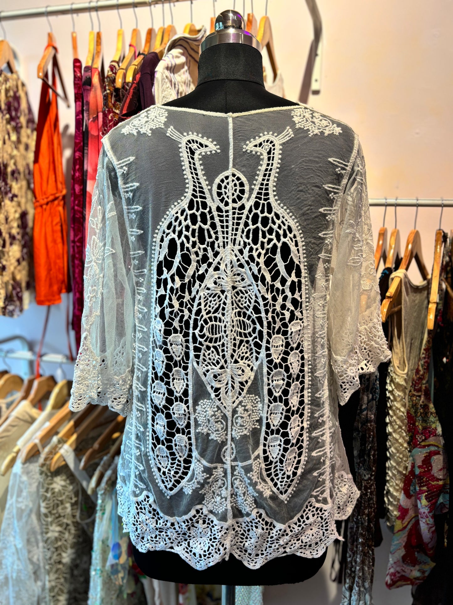 Crochet overwear with peacock motif